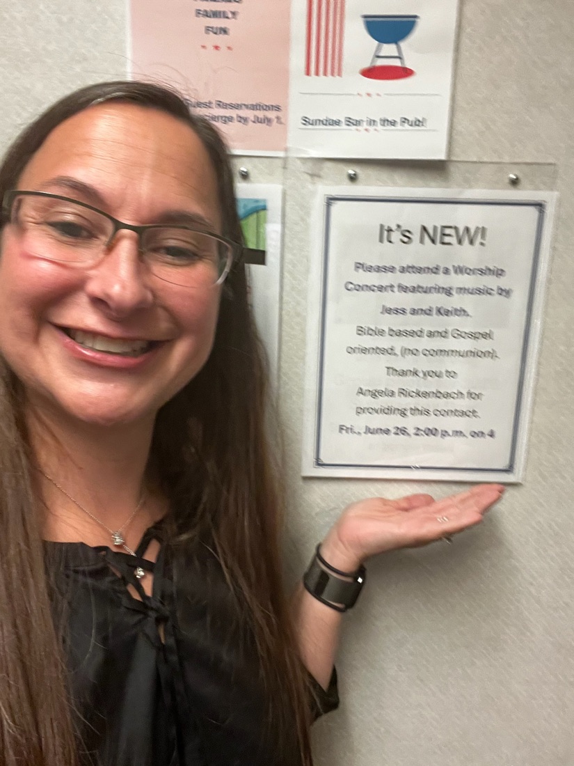 Jess pointing to a flyer announcing a worship concert