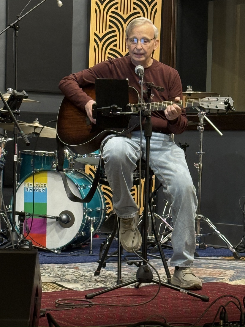 Keith playing acoustic guitar in the recording studio