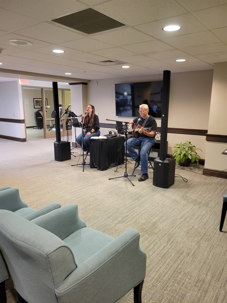 Jess and Keith performing in a retirement community lounge